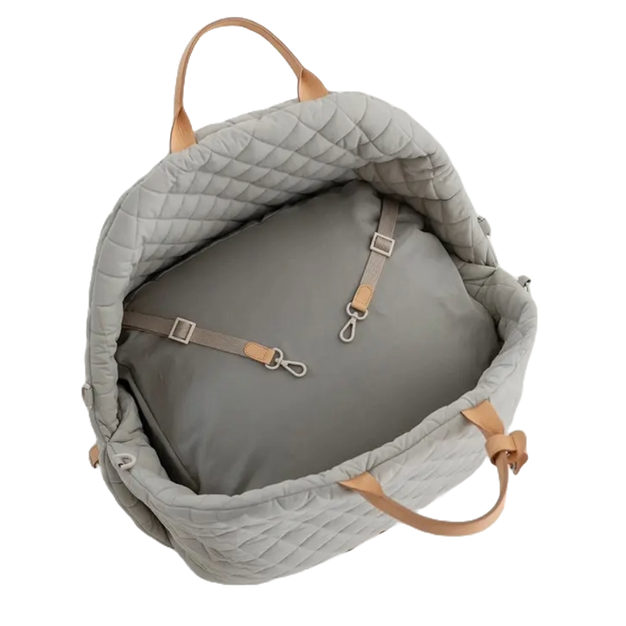 Interior view of a 3-in-1 dog travel bed showing the 2 safety clips and removable padded cushion